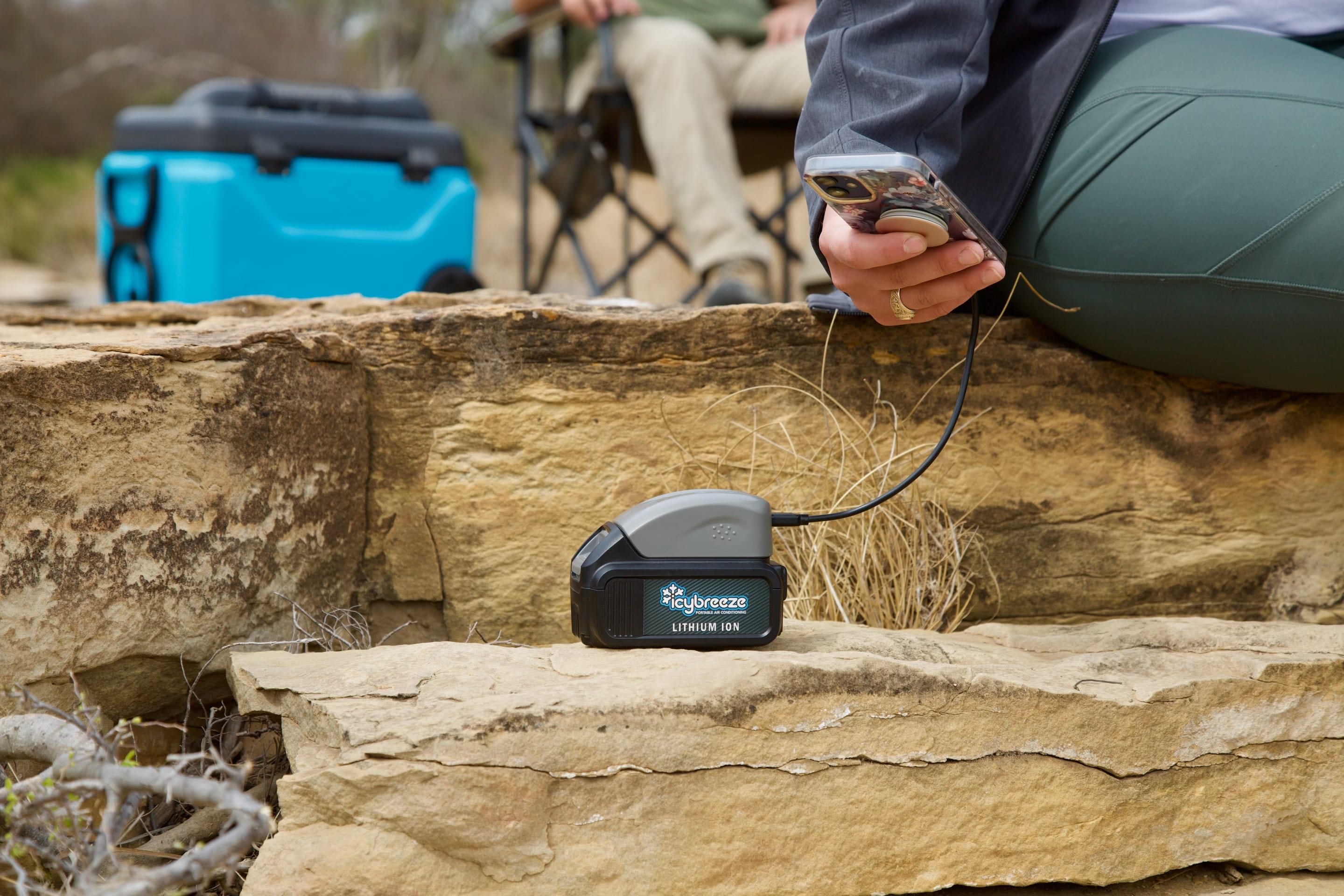 12V Charger charging a phone in a campsite